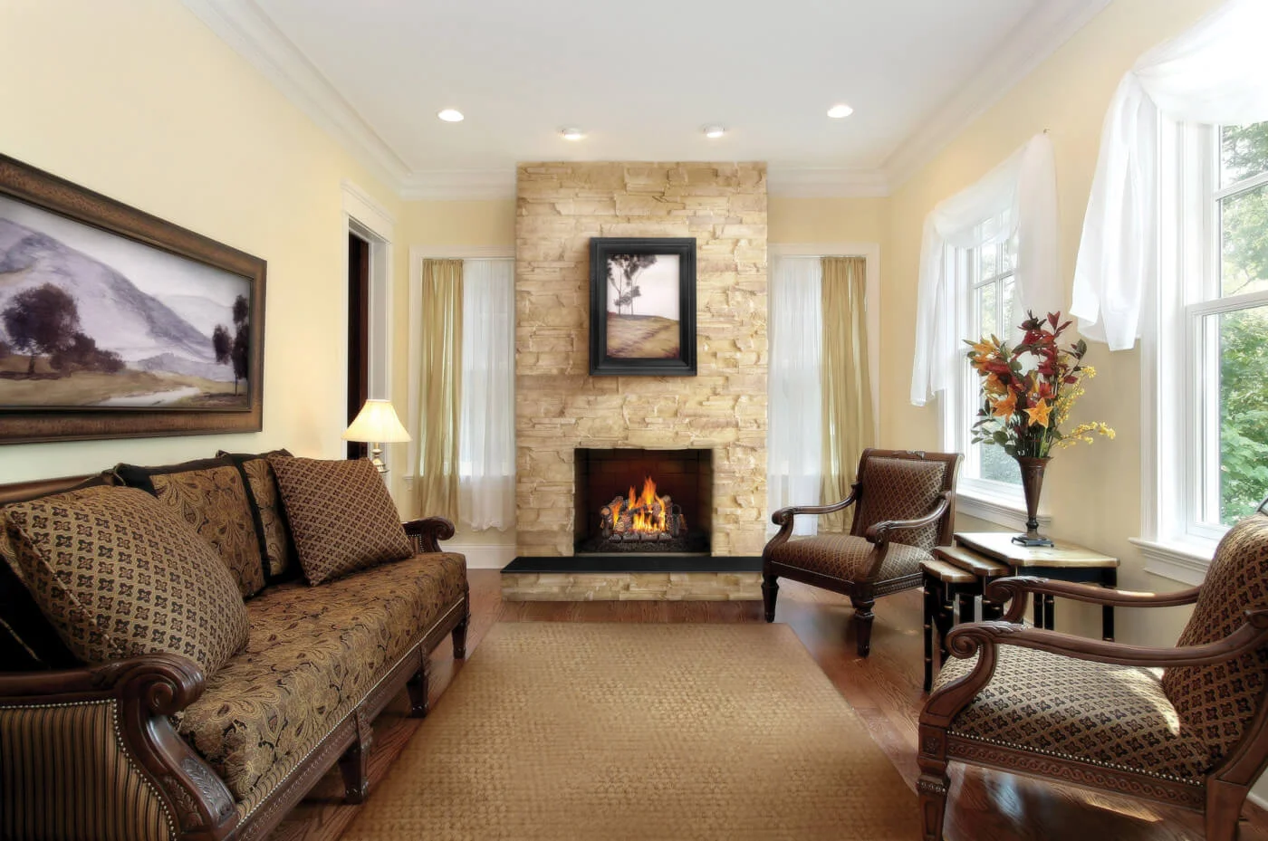 A gas log set burning in a masonry fireplace