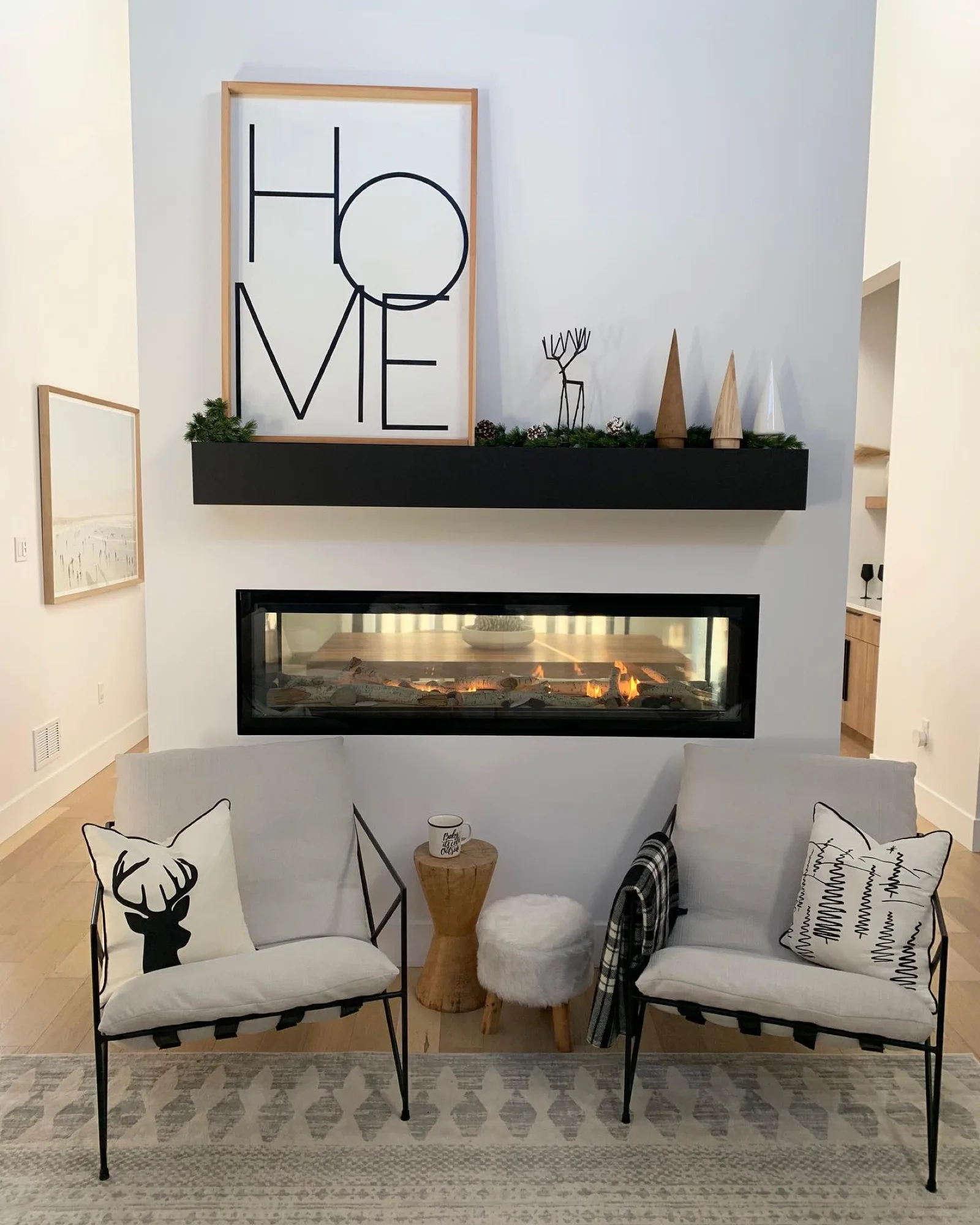 A linear fireplace beneath a HOME sign — the showroom's cozy corner
