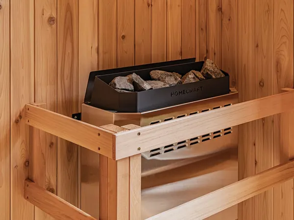The 9 kW hot-rock heater behind its cedar guard rail
