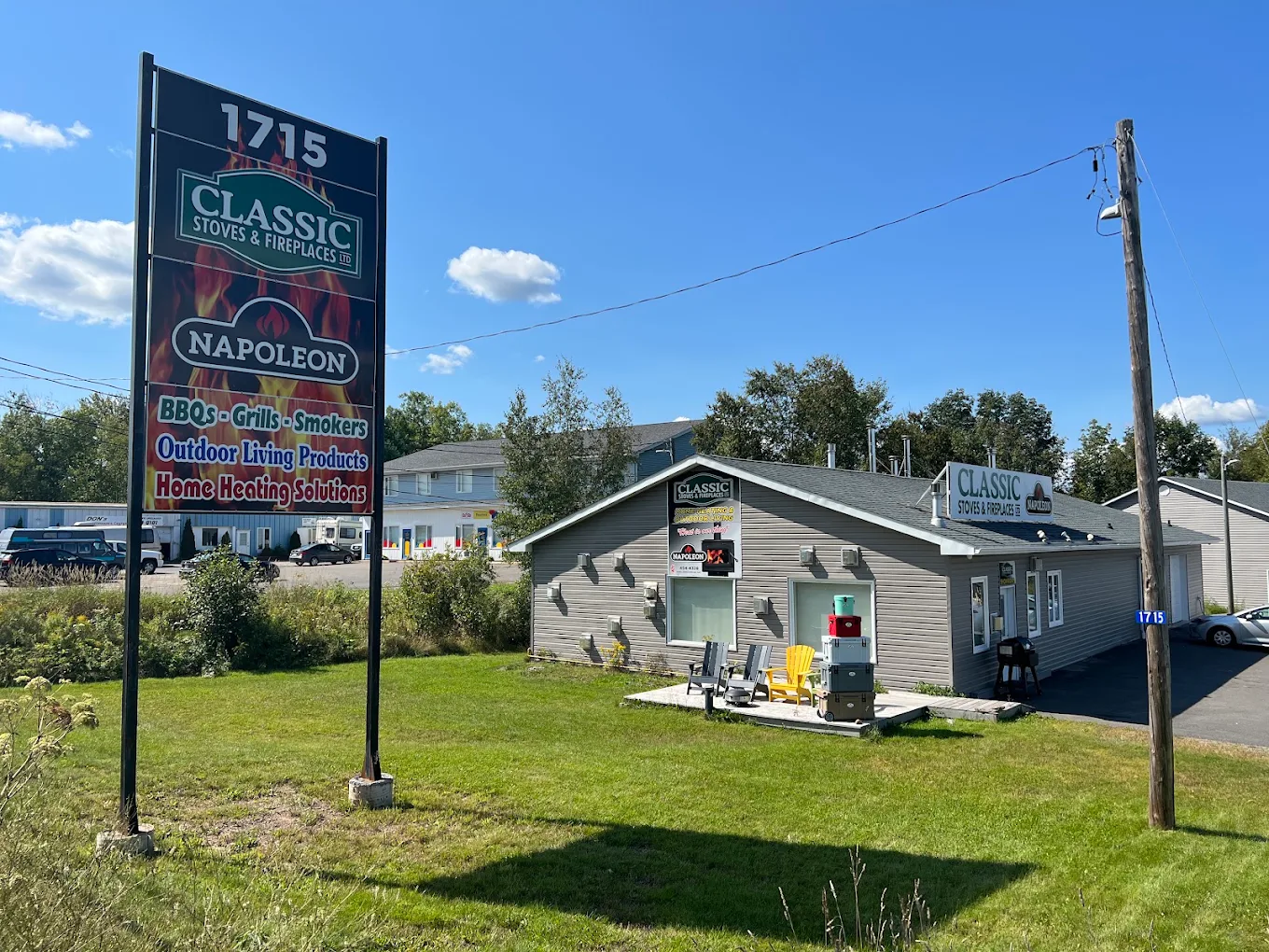 The Classic Stoves & Fireplaces roadside sign and showroom at 1715 Hanwell Road in Hanwell, New Brunswick